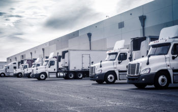 Delivering,Or,Supply,Concept,Image.,Trucks,Loading,At,Facility.
